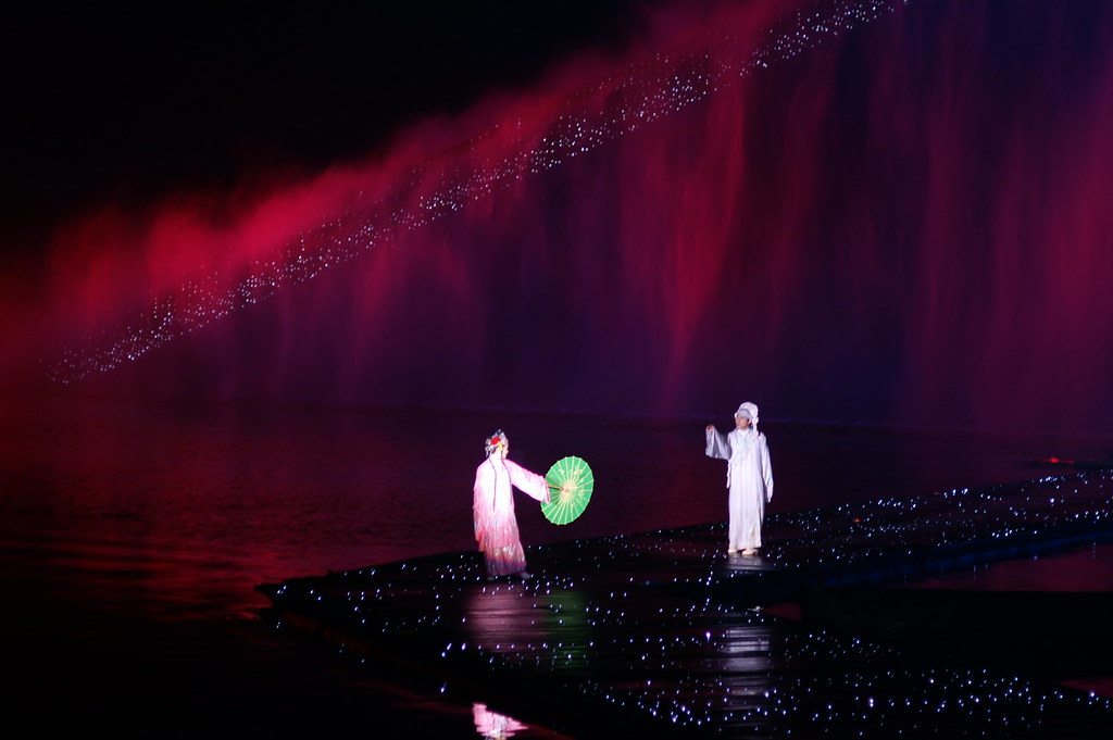 Performers on the water during Impression West Lake